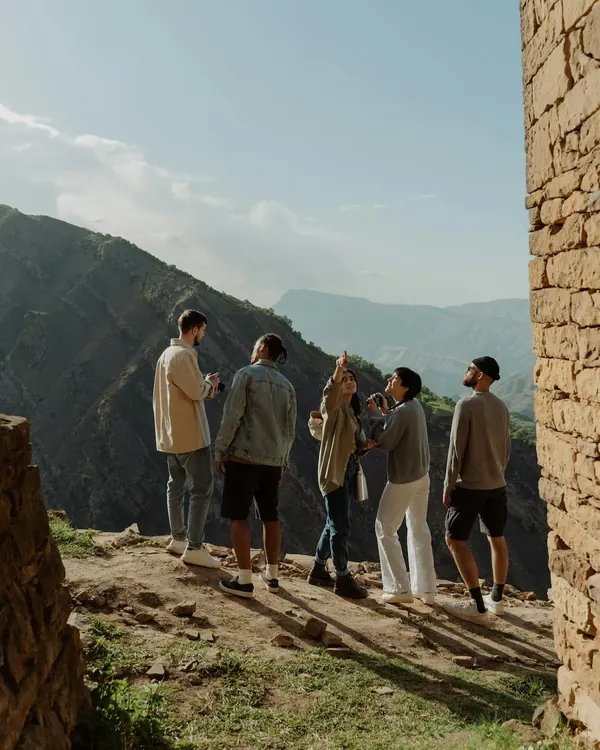 A group of friends at a mountain lookout on a day trip